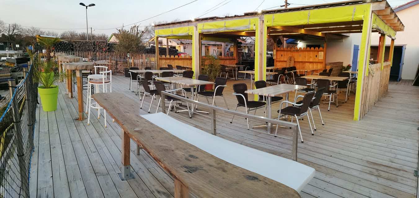 Cabane de dégustation et sa terrasse, au coucher de soleil sur le port ostréicole d'Arès